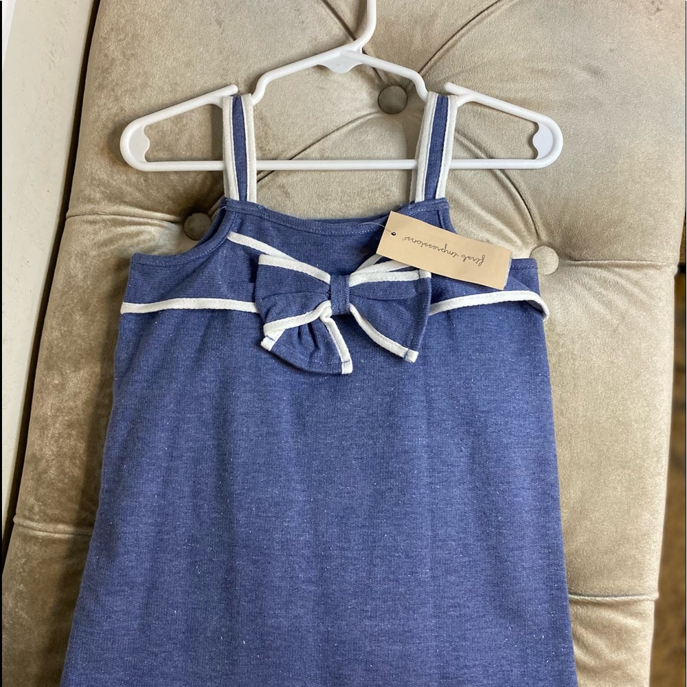 An adorable blue baby romper with a bow on the front! Snaps between the legs.